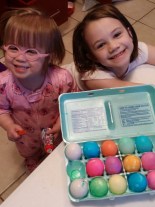 Lydia and Emma coloring Easter Eggs.